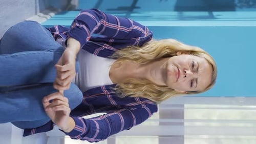 Distressed Woman Sitting on Floor Hugging Knees