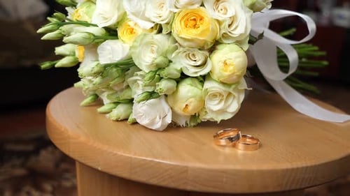 Wedding Rings with Yellow and White Rose Bouquet
