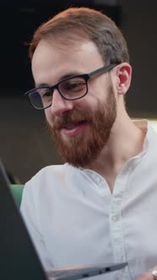 Man with Beard Chatting on Laptop Video Call