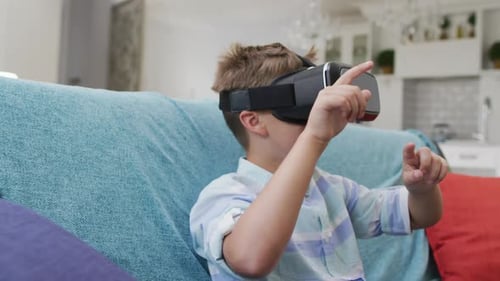 Boy Experiences Virtual Reality with Headset on Couch