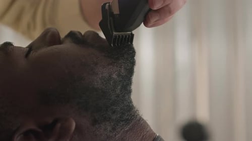 Man Gets Beard Trim with Electric Clippers