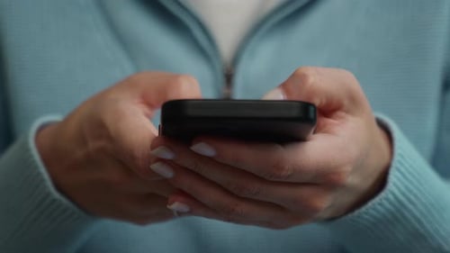 Hands Typing on Smartphone Close Up