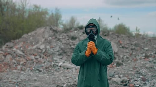 Figure in Hazmat Suit Standing Amidst Rubble