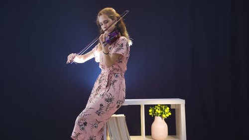 Young Woman Playing Electric Violin in Studio