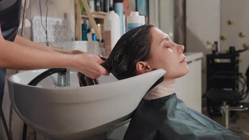 Woman Getting Hair Washed at Salon Hairdresser