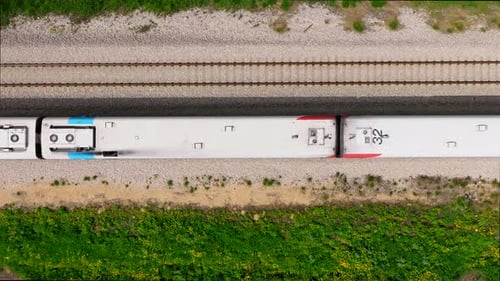 Slow motion Passenger train on a countryside railroad, Top down aerial view