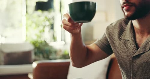 Man Sips Coffee from Mug Inside