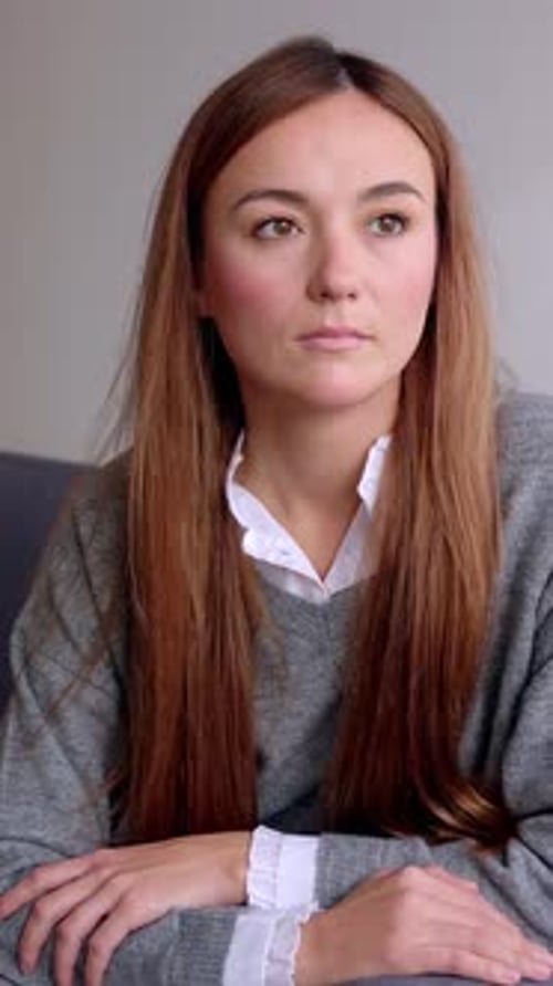 Young Woman In Sweater Looking Off to Side