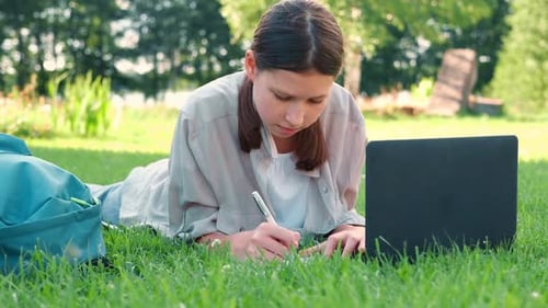 Teenage Schoolgirl Studying Reading Her Books Tablet and Notebook Sitting Outdoors Back to School