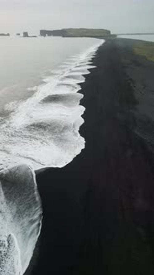 Aerial view of black sand beach in Iceland in winter.