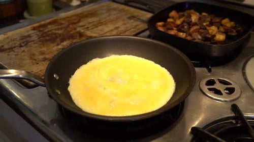 Eggs are cooked over a stove.