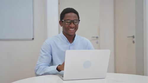 Young Man on Video Call Using Laptop