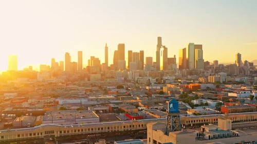 Los Angeles, LA skyline in golden sunset, aerial forward panorama flight