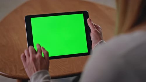 Woman Scrolling on Tablet with Green Screen
