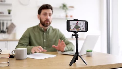 Blogger Using Mobile and Tripod for Creating Video Content
