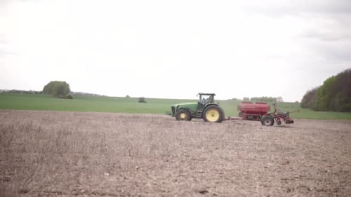 farmer on the field during planting corn and checking the soil