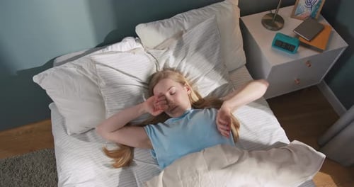 Woman Waking Up and Stretching in Bed