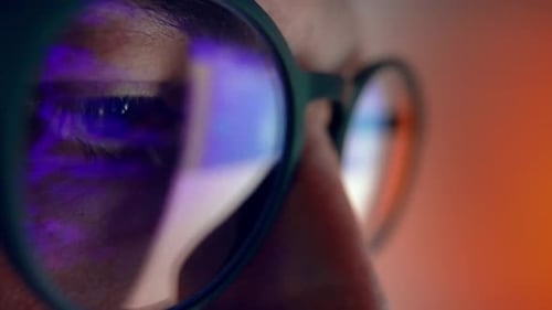 Man Wearing Glasses with Screen Reflection Macro Shot