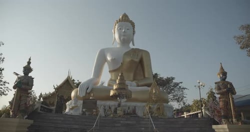 Big golden buddha with monks and buddhist figures in a holy buddhist temple in Chiang Mai, Thailand.