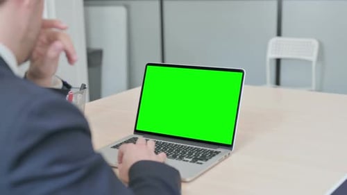 Businessman Using Laptop with Green Screen