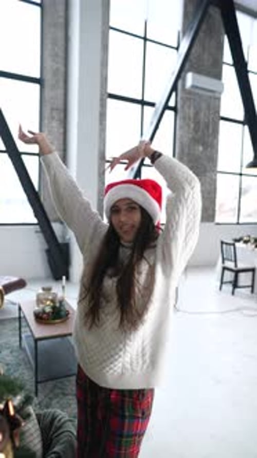 Excited Woman With Christmas Hat and Arms Raised