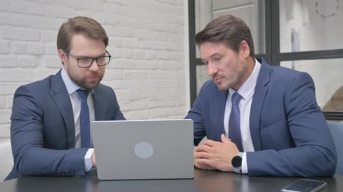 Businessmen Working on Laptop in Office Together