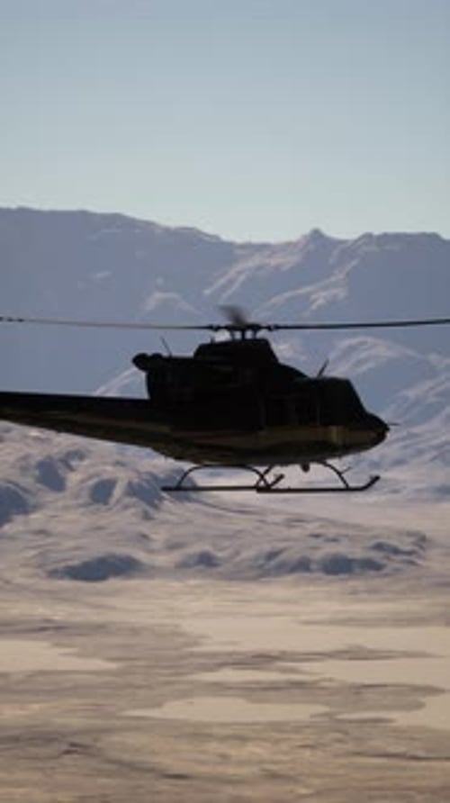 Helicopter Flying Over Mountain Range