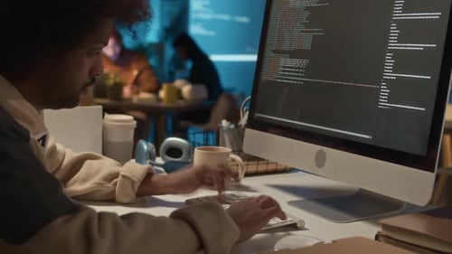 Worker Coding at Night in the Office