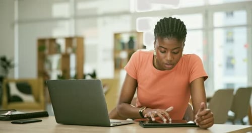 Tablet, laptop and professional black woman in the office doing research for creative project