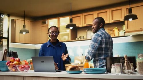 Woman Works On Laptop While Man Dances Behind Her