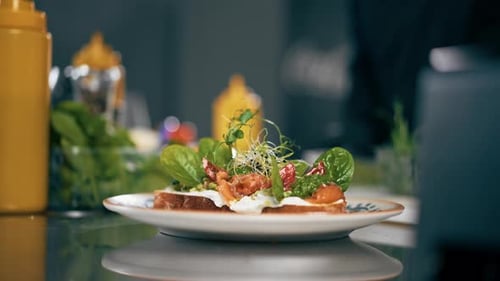 Close Up in a Professional Kitchen in a Patterned Plate There is Readymade Toast with Salmon and