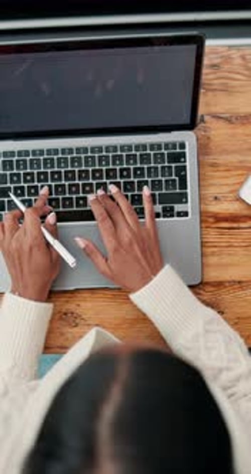 Woman Working on Laptop and Notebook at Desk