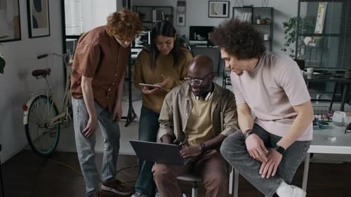 Team of Four Diverse Computer Programmers Developing Application Together