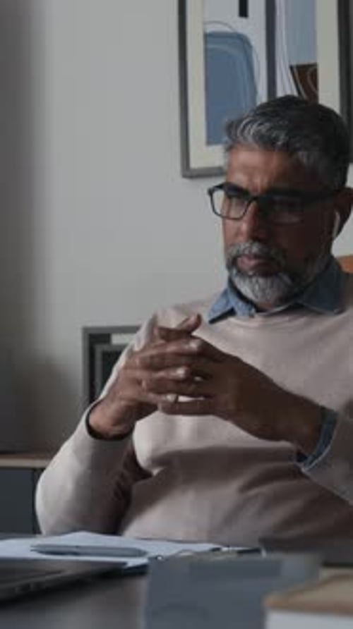 Man Talking During Virtual Meeting At Home