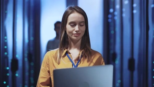 Woman Works on Laptop in Data Center Server Room