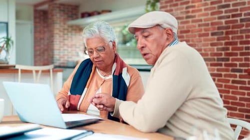 Senior couple, reading and documents at house for finance, budget planning and loan contract