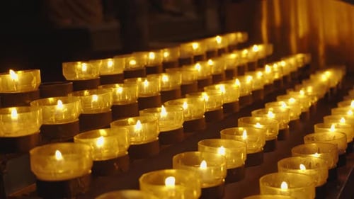 A lot of burning candles in temple. Concept of memorial day, religion, prayer, God. Flame burning