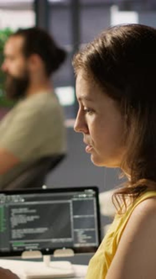 Woman Working at a Computer Writing Software Code