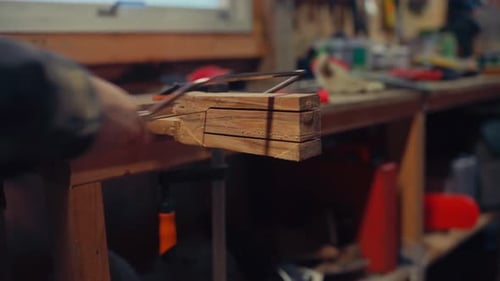 Cropped View Of A Man With Small Hand Saw. Close-up Shot