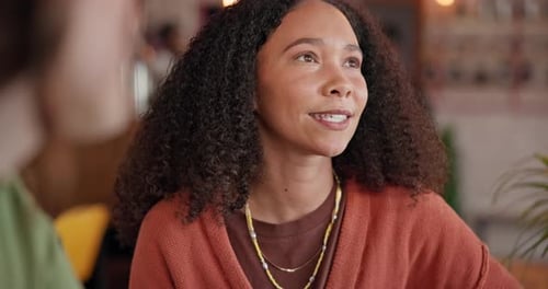 Woman, talk and smile with girl friend in coffee shop, cafe for communication, friendship and relax