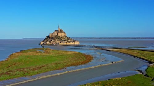 Pull back drone wide shot of Mont Saint Michel, France