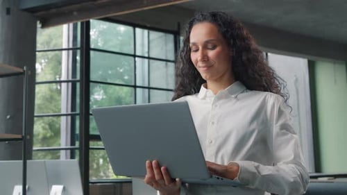 Successful Hispanic Business Woman Typing Computer in Modern Office Businesswoman Smiling Happy