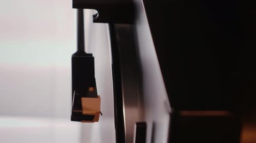 Record Player Needle Lowering onto Vinyl Disc