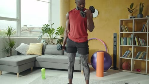 Man Strength Training at Home with Dumbbells