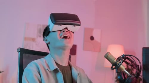 Asian Guy in VR Headset Playing Game at Night