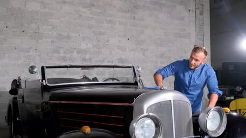 A Man Polishes a Retro Car to a Shine Car Washing and Maintenance