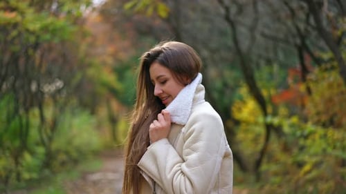 Smiling Woman Posing in an Autumn Forest