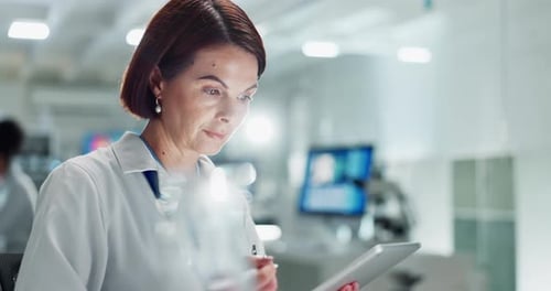 Woman Scientist Using Tablet in Bright Lab