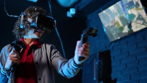 Person Uses Virtual Reality Headset and Controllers