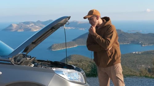 Puzzled Driver Looking at Broken Car Engine